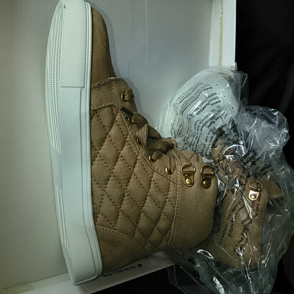 Tan high tops with quilt like detailing and lots o